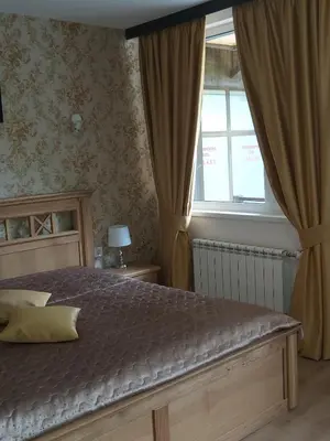 a bedroom with a bed and a window at Galaxy Hotel in Chiflik