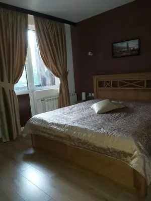 a bedroom with a bed and a large window at Galaxy Hotel in Chiflik