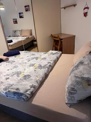 a bed with a blanket on it in a room at Apartment Lili in Blagoevgrad