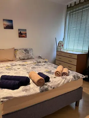 a bed with pillows on it in a bedroom at Apartment Lili in Blagoevgrad