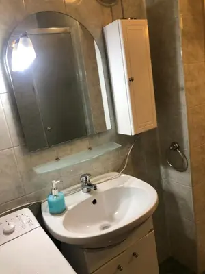 a bathroom with a sink and a mirror at Apartment Lili in Blagoevgrad