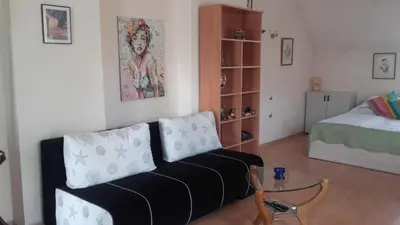 a living room with a couch and a bed at Central Park Studio in Plovdiv