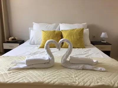 two swans towels are made to look like hearts on a bed at PM Mountain View Fireside Retreat Bansko in Bansko