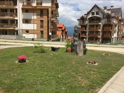 a park in the middle of a city with buildings at PM Mountain View Fireside Retreat Bansko in Bansko