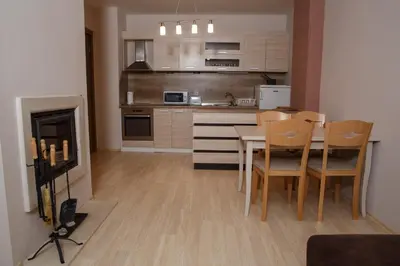 a kitchen with a table and chairs in a room at PM Mountain View Fireside Retreat Bansko in Bansko