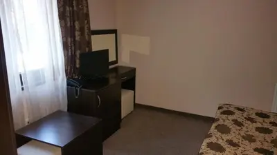 a bedroom with a desk and a bed and a window at Hunting Residence Lodge in Panichishte