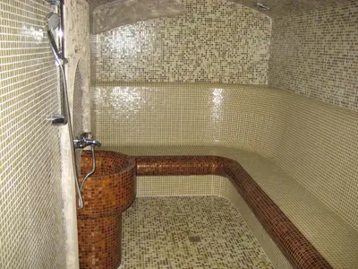 a bathroom with a shower with a bath tub at Hunting Residence Lodge in Panichishte