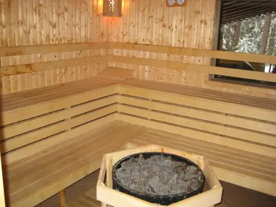 a wooden sauna with a large tub in it at Hunting Residence Lodge in Panichishte