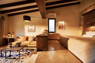 a bedroom with a bed and a couch in a room at Zornitza Family Estate Relais & Chateaux in Melnik