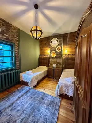 a bedroom with two beds and a chandelier at Villa Adis with Hot Pool & Jacuzzi by BookVillaBG in Borovets