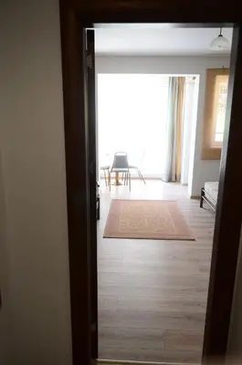 an open door to a room with a living room at Main Street Apartment in Sandanski