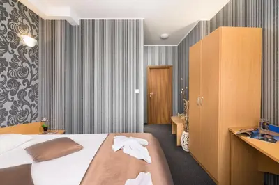 a hotel room with a bed and a bathroom at Hotel Central Point in Sofia
