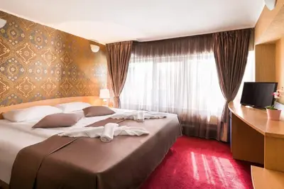 a hotel room with a large bed and a window at Hotel Central Point in Sofia