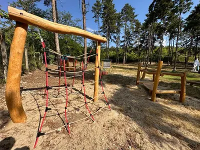 a playground with a swing in a park at Esterra Vini Guest House in Perushtitsa