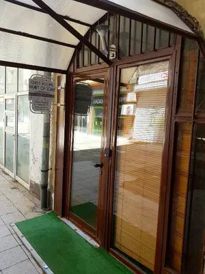 a front door of a building with a green floor at Serdika Rooms in Sofia