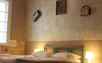 a bedroom with a bed with a wall covered in music at Serdika Rooms in Sofia