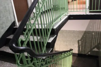 a black bench sitting on the side of a staircase at Serdika Rooms in Sofia