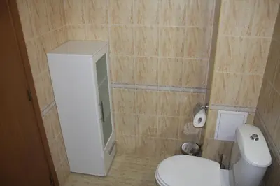 a bathroom with a white toilet and a mirror at Studio Moni in Pamporovo