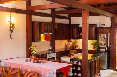 a large kitchen with a table and a refrigerator at Grancharova Guest House in Bansko