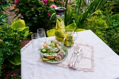 a plate of food on a table with a bottle at Grancharova Guest House in Bansko