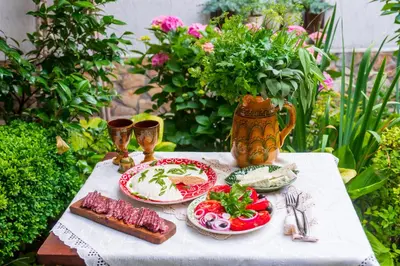 a table with plates of food on top at Grancharova Guest House in Bansko