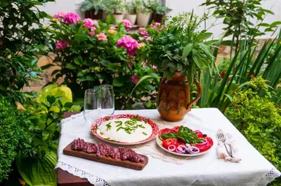 a table with two plates of food and a cake at Grancharova Guest House in Bansko