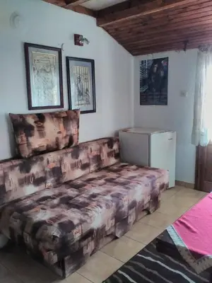 a large couch in a room with a refrigerator at Bonbon Guest House in Panagyurishte