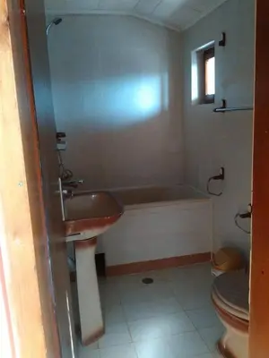 a bathroom with a sink and a tub and a toilet at Bonbon Guest House in Panagyurishte