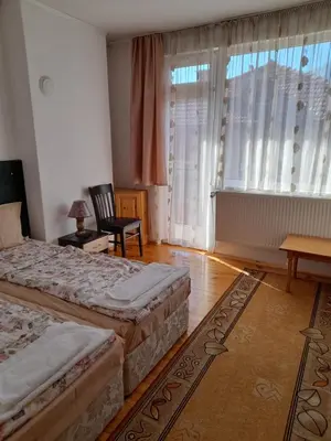 a hotel room with two beds and a window at Yana Guest House in Dobrinishte