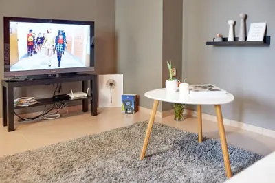 a living room with a tv and a table at Apartment 11 in Sofia