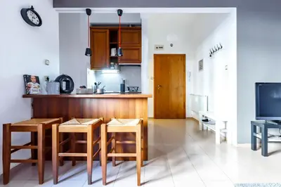 a kitchen with a table and some chairs and a counter at Apartment 11 in Sofia