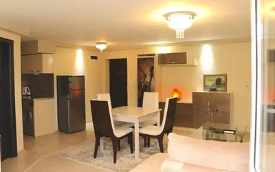 a dining room and kitchen with a table and chairs at Sundance Apartments in Sandanski