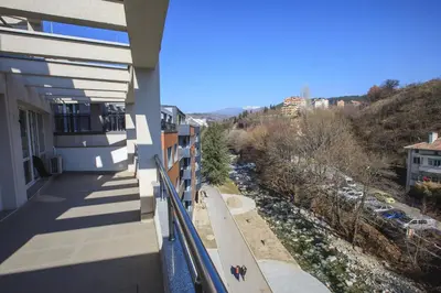 a balcony of a building with a view of a river at Sundance Apartments in Sandanski