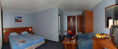 a hotel room with a bed and a couch at Hotel Kibella in Sofia