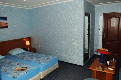 a hotel room with a bed and a table at Hotel Kibella in Sofia