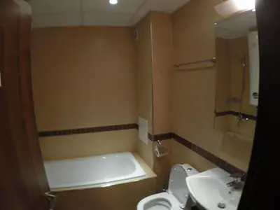 a bathroom with a tub and a toilet and a sink at Oksana's Apartment at Infinity in Bansko