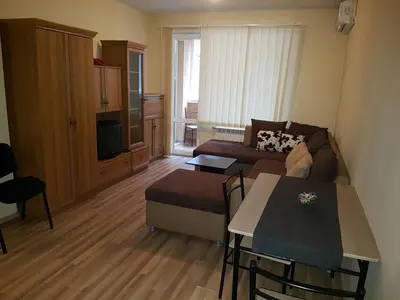 a living room with a couch and a table at Pirotska Apartment GN / FREE GARAGE in Sofia