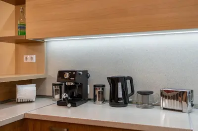 a kitchen counter top with a coffee maker on it at Spacious 2-Bedroom Apartment - Ideal for Families & Groups - City Center in Sofia