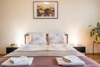 a bedroom with a bed with towels on it at Spacious 2-Bedroom Apartment - Ideal for Families & Groups - City Center in Sofia