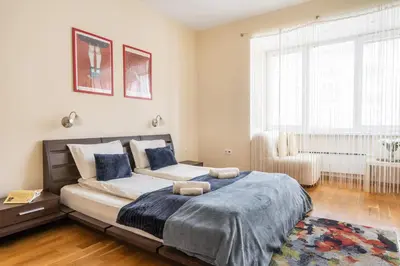 a bedroom with a large bed and a window at Spacious 2-Bedroom Apartment - Ideal for Families & Groups - City Center in Sofia