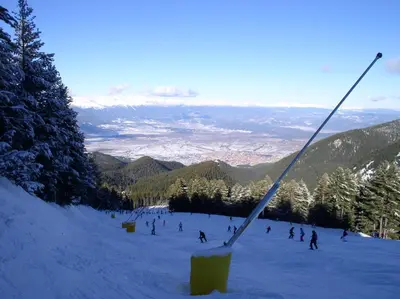 a group of people skiing down a snow covered slope at LVV Pirin Golf Villa in Bansko