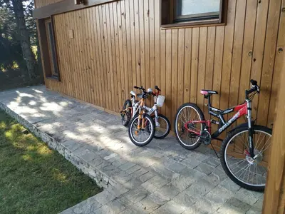 three bikes are parked next to a building at LVV Pirin Golf Villa in Bansko