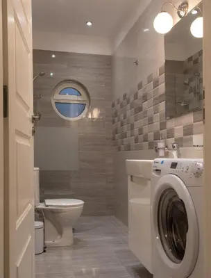 a bathroom with a washing machine and a toilet at The North Tower Apartment in Sofia