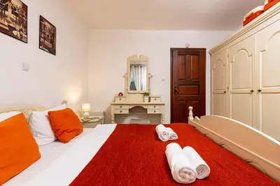 a bedroom with a large bed with towels on it at The House With The Piano in Plovdiv