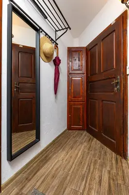 a hallway with a mirror and a door at The House With The Piano in Plovdiv