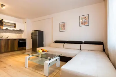 a living room with a couch and a table at Ibar Apartment & Garage in Plovdiv