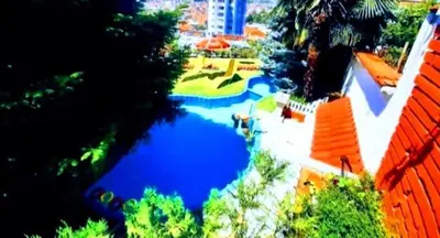 a view of a large pool of water with trees at Guest House Sofia in Sandanski