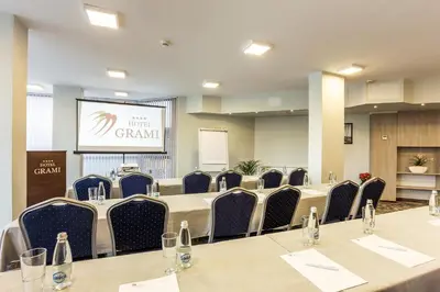 a conference room with a long table and chairs at Grami Hotel Sofia in Sofia
