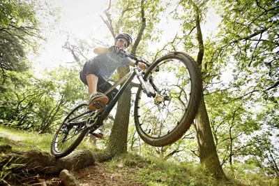a man doing a trick on a bike in the woods at Villa Rupcovoto in Smolyan