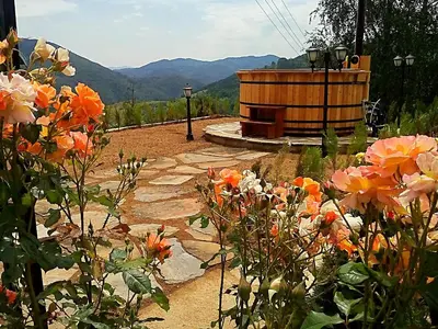 a garden with flowers in front of a building at Villa Rupcovoto in Smolyan